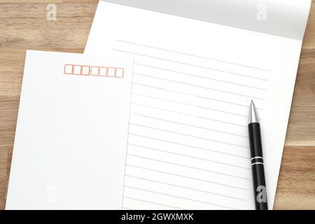 Japanese writing letter paper with ballpoint pen on wooden background Stock Photo
