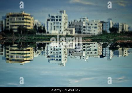 Reflection Of Buildings In Lake Against Sky