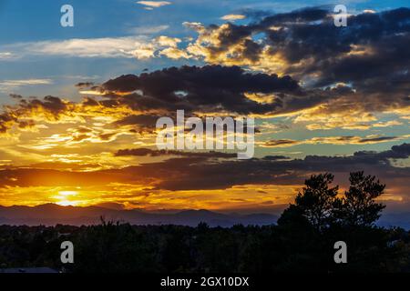 Sunset skies in the fall over the suburban neighborhood in Aurora, Colorado Stock Photo