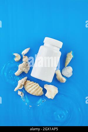 Jar mockup on blue background in water with waves and seashells Stock Photo