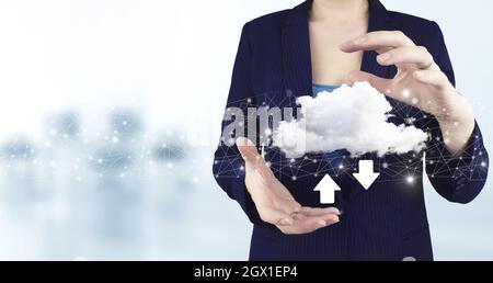 Download Data Storage Business Technology Network Concept. Two hand holding virtual holographic cloud, download, data icon with light blurred backgrou Stock Photo