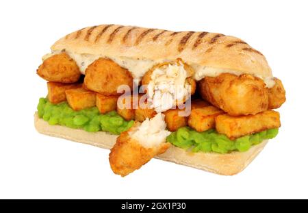 Fish and chips sandwich with battered cod fish and mushy peas in a ...