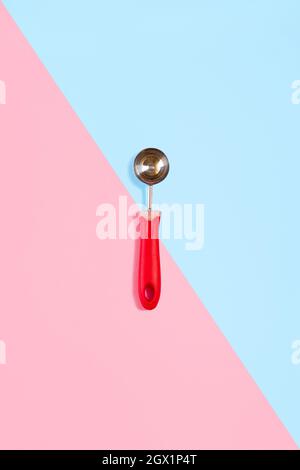 Ice cream scoop isolated on turquoise and pink. Top view Stock Photo