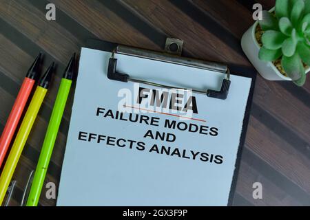 FMEA - Failure Modes and Effects Analysis write on a paperwork isolated on Wooden Table. Stock Photo