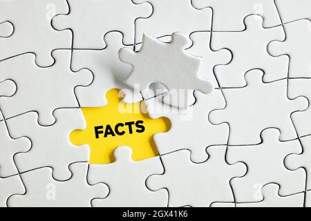 The word facts on yellow missing puzzle piece. To reveal, discover or expose facts concept. Stock Photo