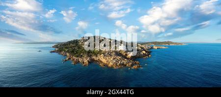 View from above, stunning aerial view of the Vedetta di Punta Sardegna, a white lighthouse located an a granitic, rocky coast. Stock Photo