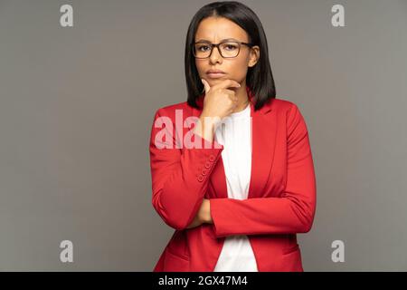 Puzzled thoughtful businesswoman doubtful think on business development strategy or partnership Stock Photo