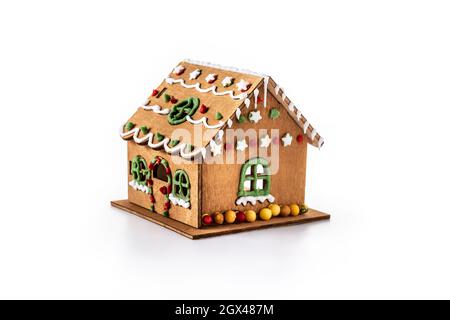 Christmas gingerbread house decorated with candies and glaze isolated on white background Stock Photo