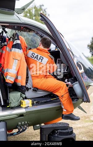 02 October 2021, North Rhine-Westphalia, Mönchengladbach: The pilot of a SAR helicopter of the type Airbus H145, sits in his cockpit during the 'Meeting Day with the German Armed Forces' and 37th International Mönchengladbach Military Competition. Photo: Marcel Kusch/dpa Stock Photo