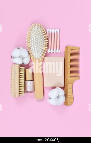 Eco friendly wooden beauty and hygiene products like comb and soap arranged on pink background Stock Photo