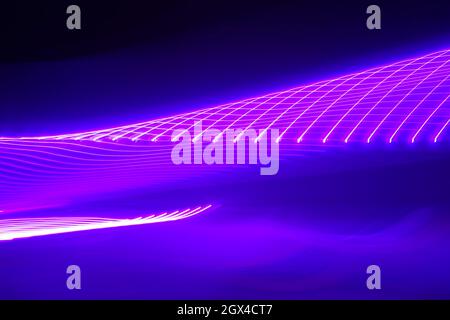 Neon pink light trails twisting tunnel pattern Stock Photo