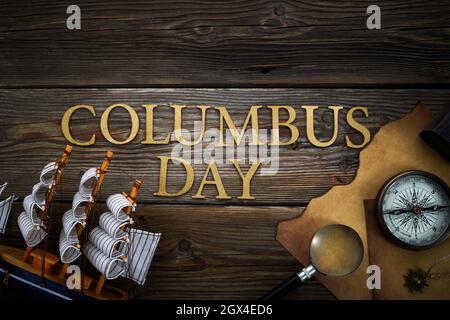 Columbus Day. Vintage discovery equipment with copy space on dark wooden background. Stock Photo