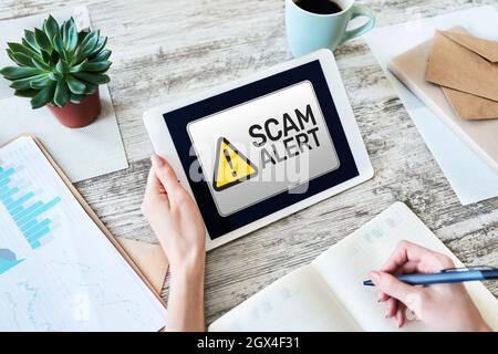 Scam alert detecting warning. Notification on device screen. Stock Photo