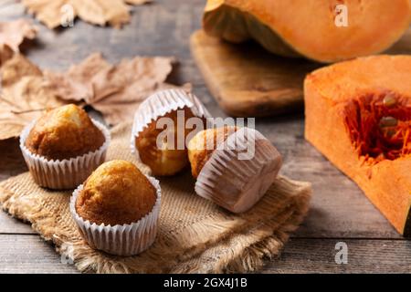 Pumpkin muffins on wooden table Stock Photo