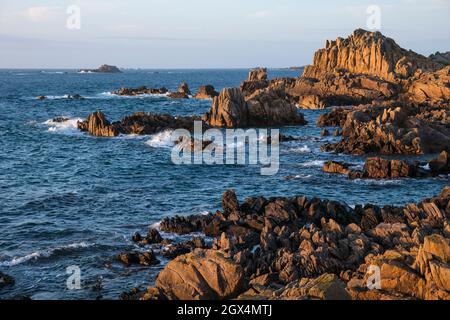 Last light on the rocky coast at Fort Hommet, Guernsey, Channel Islands Stock Photo