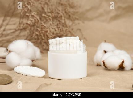 White cotton sponges on brown background. Design for the beauty, medicine and cosmetics industry Stock Photo