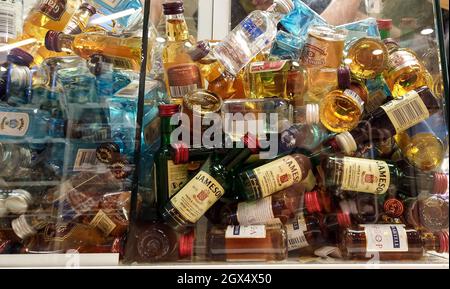 collectible mini bottles of alcohol at the duty free market shop. Little alcohol drinks in glass box. Bodrum, Turkey - September 14, 2021 Stock Photo