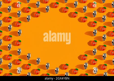 Creative orange pattern made of pumpkin and skull, Halloween concept Flat flat, top view, copyspace Stock Photo