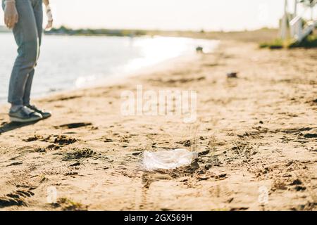 Used plastic wasted water bottle washed up on the shore of a beach, highlighting the worldwide crisis of plastic pollution. Environment ecology Stock Photo