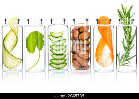 Homemade skin care with natural ingredients  aloe vera ,cucumber ,almonds, centella asiatica and rosemary in glass bottles isolate on white background Stock Photo