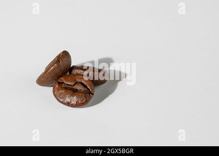 tree grains of coffee close up isolated on white background Stock Photo