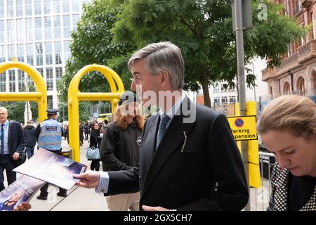 Manchester, UK. 04th Oct, 2021. Jacob Rees-Mogg takes a wrong turn out of Midland hotel and is confronted by anti government protestors where he is handed and accepts a copy of the new statesman. Manchester St Peters sq. Manchesr UK. Credit: Gary Roberts/Alamy Live News Stock Photo