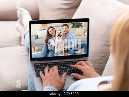 Online Call. Unrecognizable Woman Using Laptop For Videoconference With Friends Stock Photo