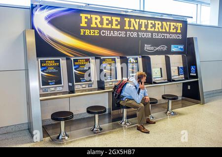 Dallas Texas,Dallas Ft. Fort Worth International Airport American Airlines,terminal gate free Internet charging station,man male smartphone cell phone Stock Photo