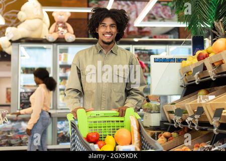 African American Man Shopping Grocery Products Posing In Store Stock Photo