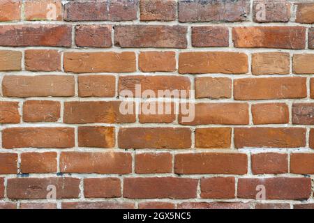 Red brick wall texture with cracks and scratches for background Stock Photo