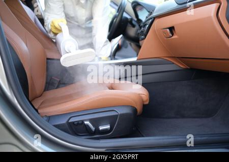 Detailing the car. Cleaning the car interior with steam. Car