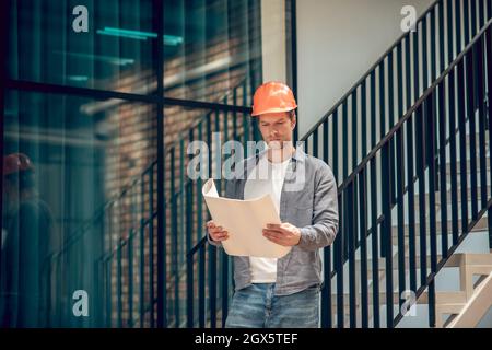 Man looking at sketch on paper in hands Stock Photo