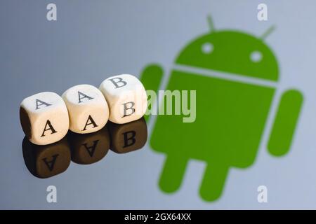 Abbreviation AAB(Android App Bundle) is made of cubes with letters. Android logo on the background. Stock Photo