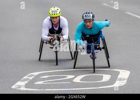 Tatyana McFadden and Merle Menje racing in the Virgin Money London Marathon 2021 wheelchair race, in Tower Hill, London, UK. Wheelchair athletes race Stock Photo