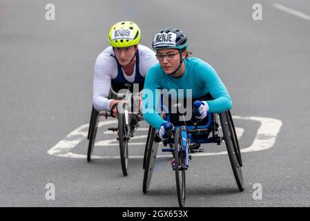 Tatyana McFadden and Merle Menje racing in the Virgin Money London Marathon 2021 wheelchair race, in Tower Hill, London, UK. Wheelchair athletes Stock Photo