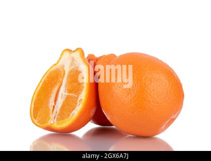 One half and two whole sweet organic minneola, close-up, isolated on white. Stock Photo