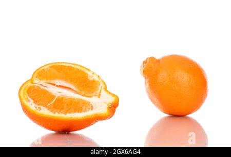 One half and one whole sweet organic minneola, close-up, isolated on white. Stock Photo