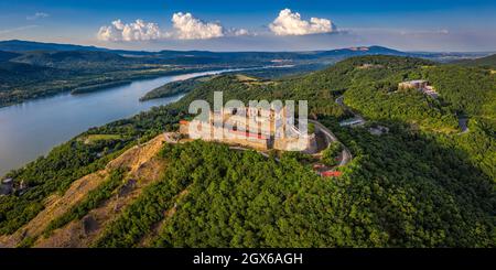 Visegrad, Hungary - Aerial panoramic drone view of the beautiful high castle of Visegrad with summer foliage and trees. Dunakanyar and blue sky with c Stock Photo