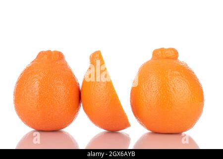 One half and two whole sweet organic minneola, close-up, isolated on white. Stock Photo