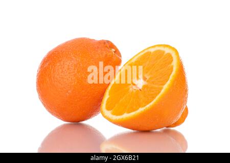 One half and one whole sweet organic minneola, close-up, isolated on white. Stock Photo