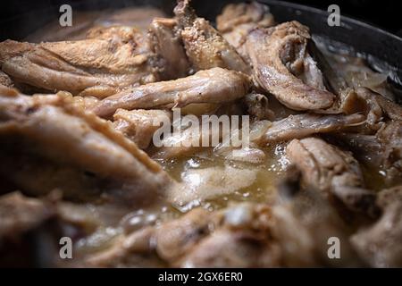 Chicken wings are cooked in their own juice in a pan Stock Photo