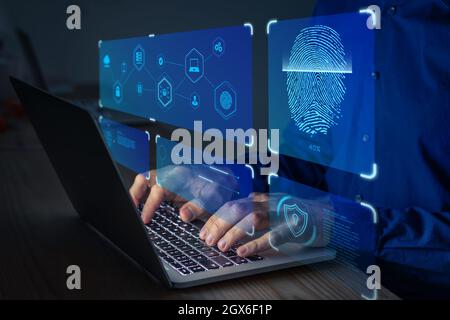 Fingerprint scan for secure access to protected data network with biometrics. Person using finger print authentication technology on laptop computer t Stock Photo