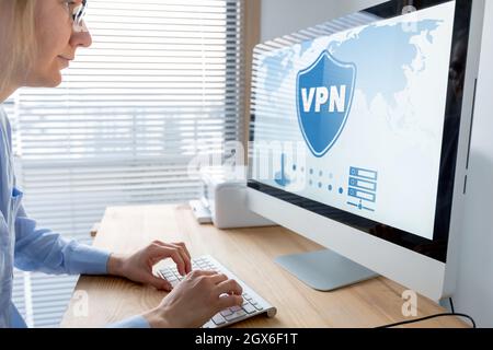 VPN secure connection for telecommuter. Person using Virtual Private Network technology on computer to create encrypted tunnel to remote server on int Stock Photo