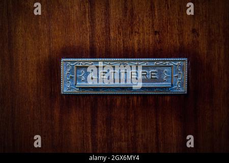 Italian postbox, vintage metal postbox on wooden door Stock Photo