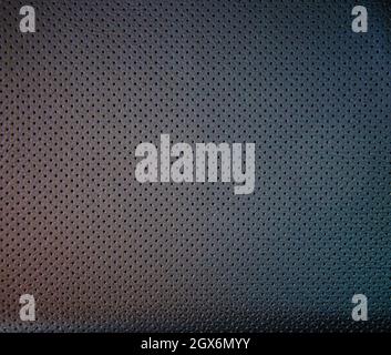 soft colored dark perforated leather texture, leather textured background Stock Photo