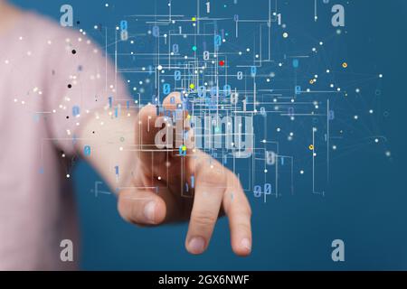 Man tapping on a hologram of binary codes - digital transformation concept Stock Photo
