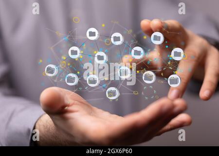 Hologram of interconnected digital files or storage network on the palm of a businessman Stock Photo