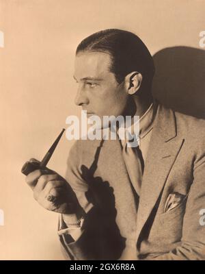 Rudolph Valentino (1895-1926), Italian Actor, half-length Portrait with Smoking Pipe, Russell Ball, 1925 Stock Photo
