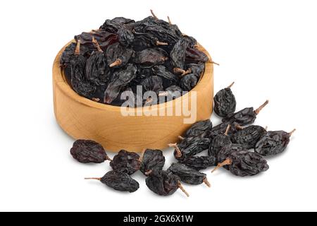 Yellow raisins in wooden bowl isolated on white background with clipping path and full depth of field