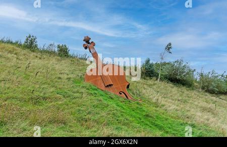 This Corten steel fiddle statue is on the N5 bypass near Longford town, erected in tribute to the tradition of fiddle playing in the area. Stock Photo